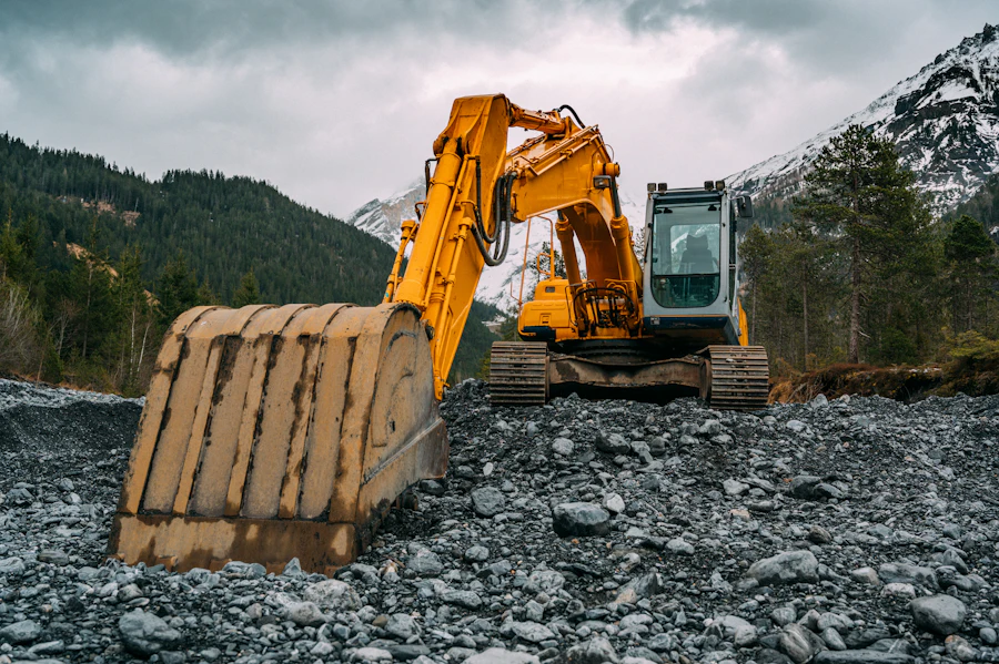 Yellow excavator on rocky ground