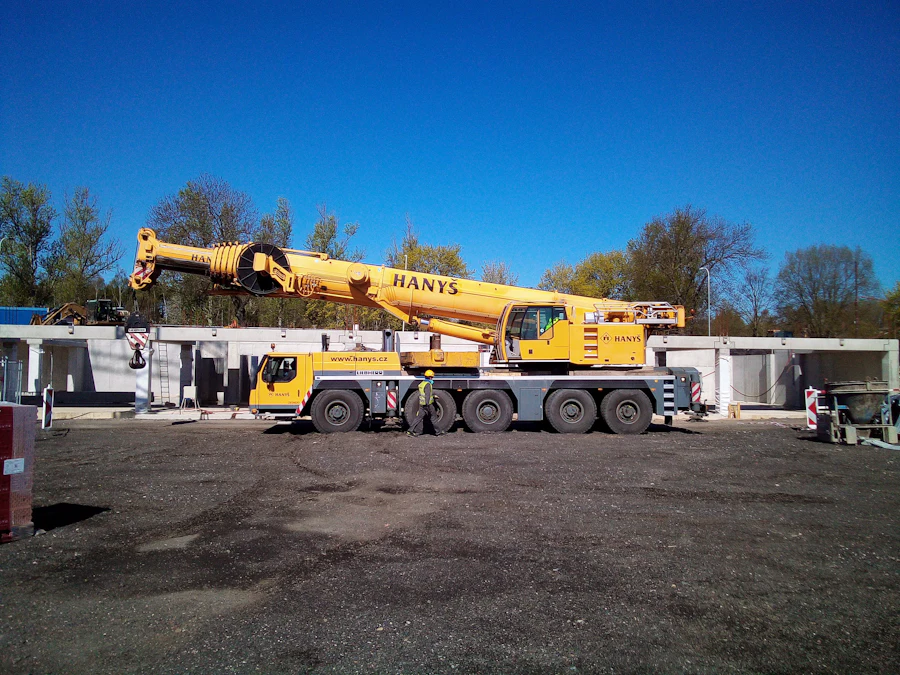 Yellow mobile crane parked in a yard