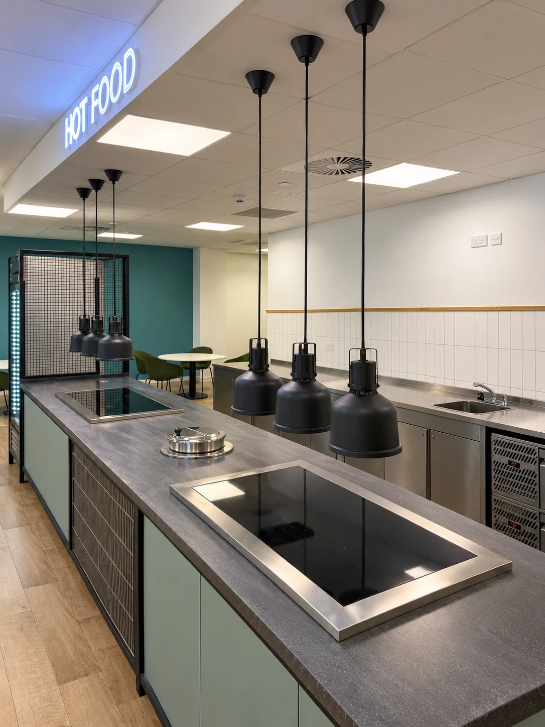 Commercial kitchen at move-in with clean walls, counters and induction hobs