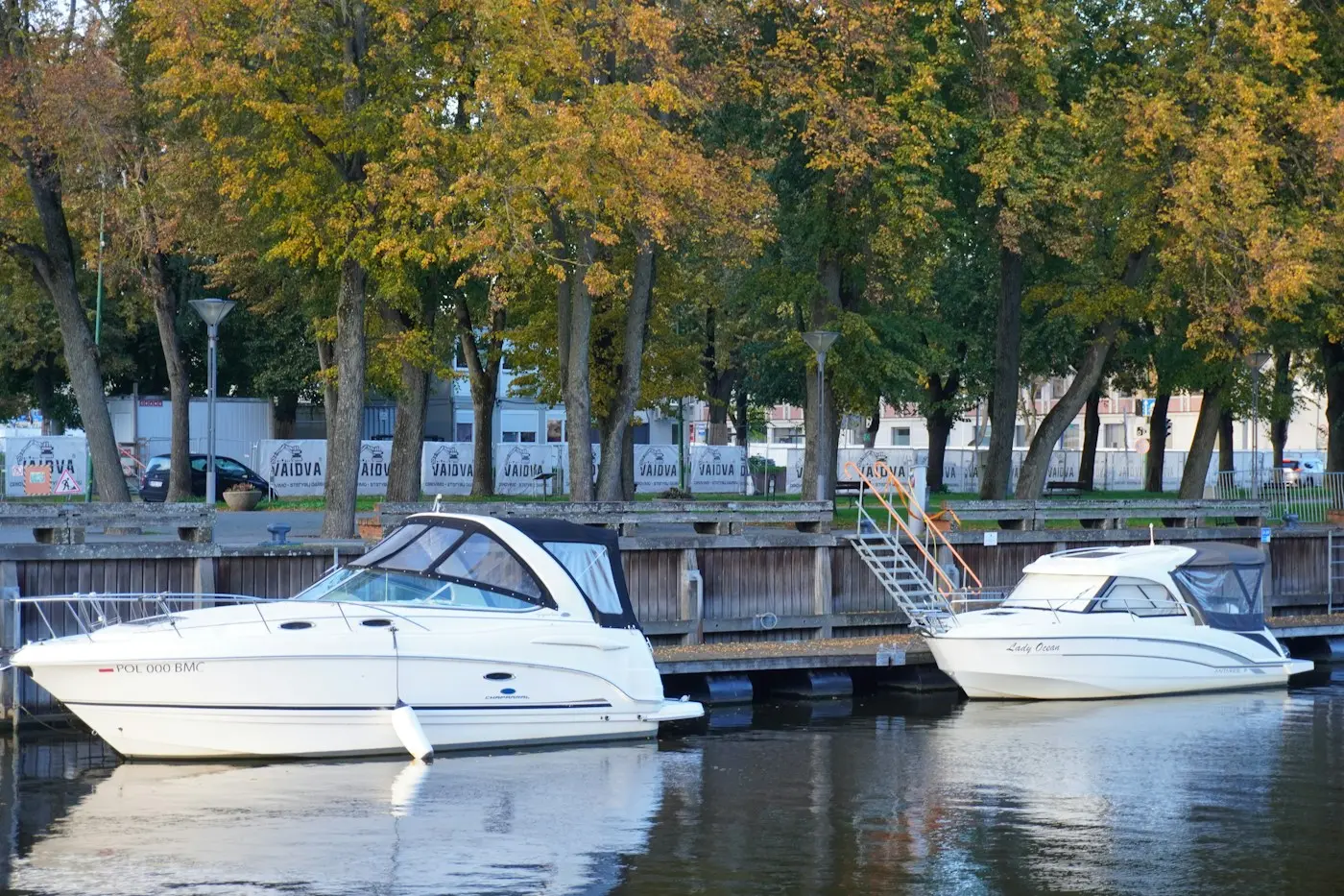 Motor boats moored at a wooden dock